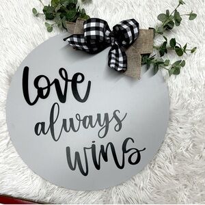 Gray Round Wall Decor with Black Text and Bow